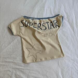 with jean cream and blue off the shoulder top with rhinestone detail